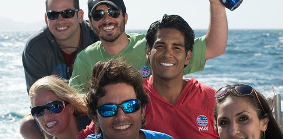 Happy scuba divers on a boat in Kauai