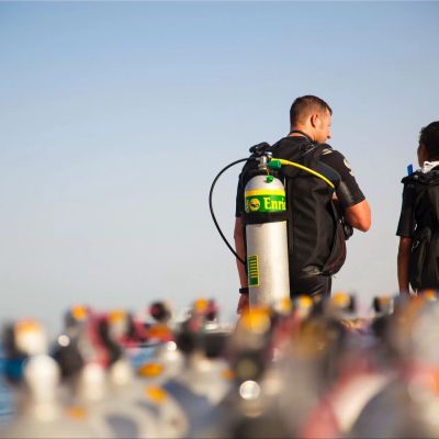 Divers wearing Nitrox scuba diving tanks