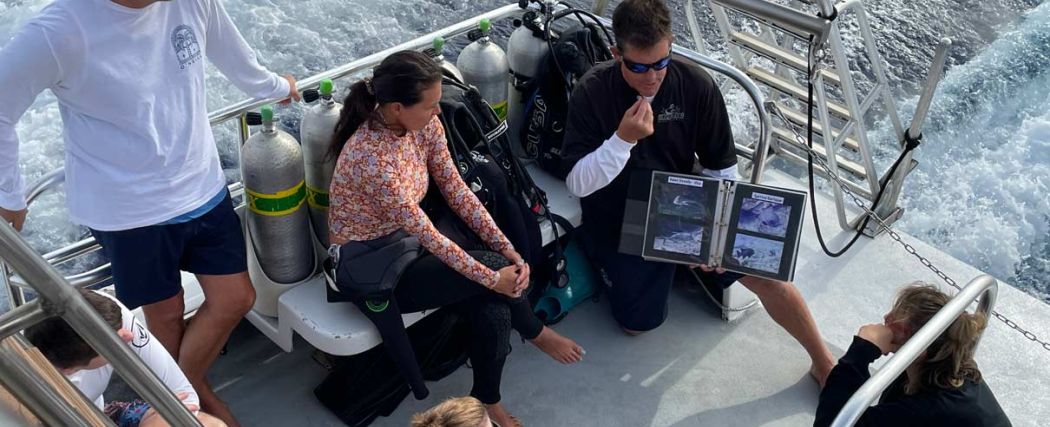 PADI instructor briefing scuba divers about to go diving in Niihau