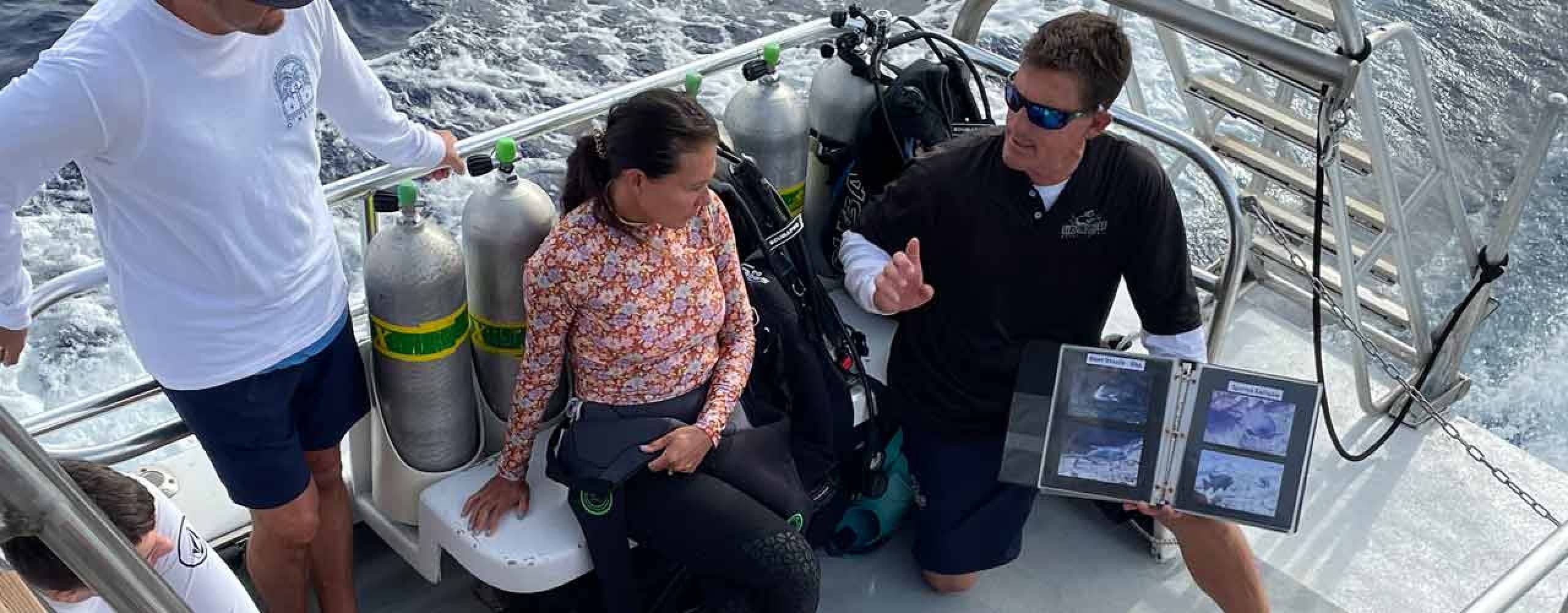 PADI Divemaster briefing guests before getting in the water for a scuba dive in Kauai