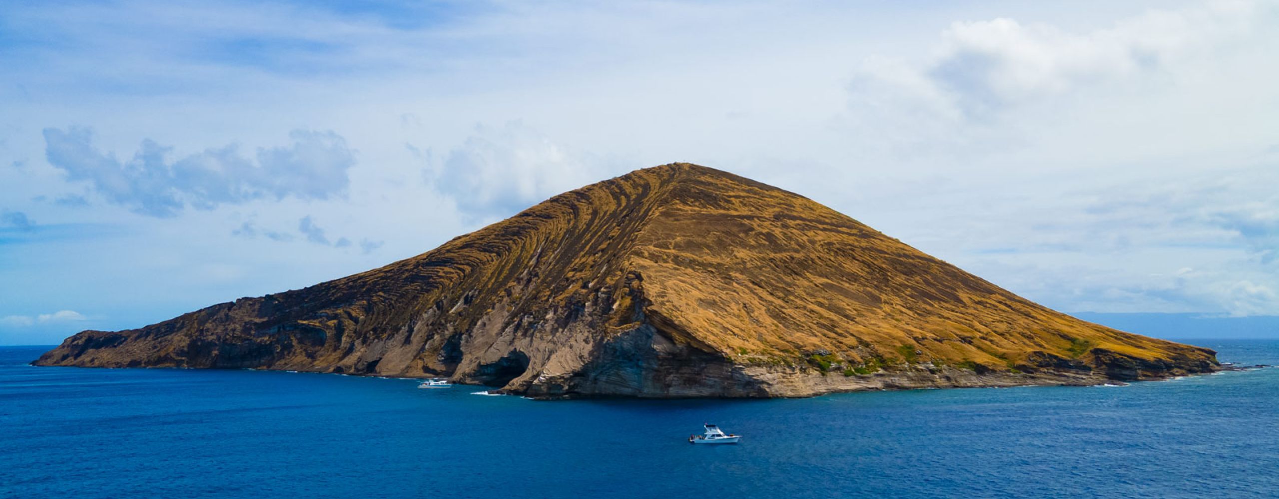 Island of Niihau drone shot with the scuba diving boat in the foreground
