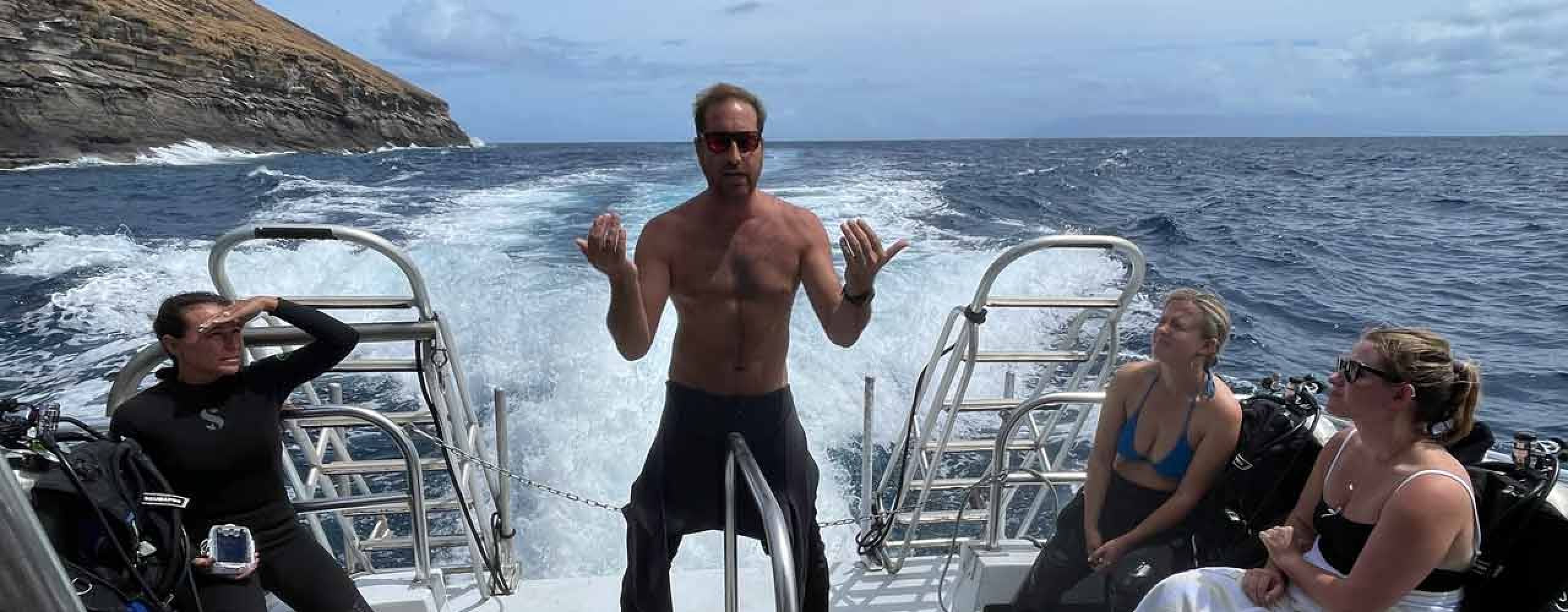 Scuba Instructor explaining boat safety to all the guests on the boat